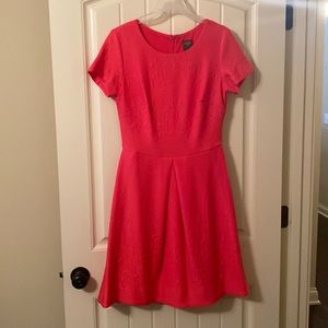 Taylor dress, coral in color with a raised textured design in the fabric